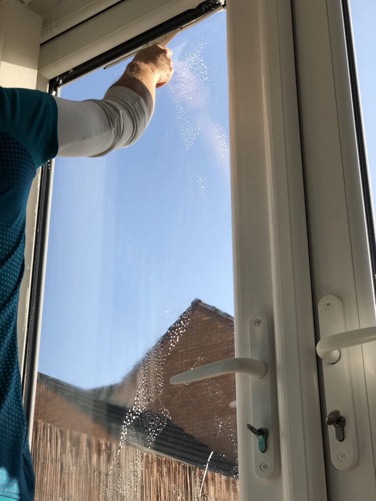 Window cleaning with squeegee